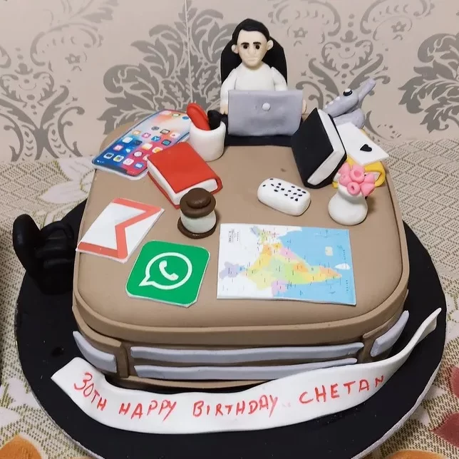 Birthday Cake with fondant laptop, bags and books.